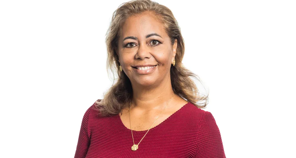 Ms Vanessa Elliott wearing brown and black top with baroque fillagrie pattern