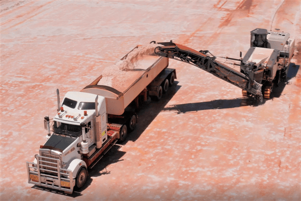 Kalium Lakes aerial view of machinery conveying salt into the back of a semi trailer for processing