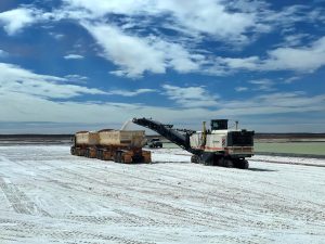 Kalium Lakes Trucks pouring salt product into a road train