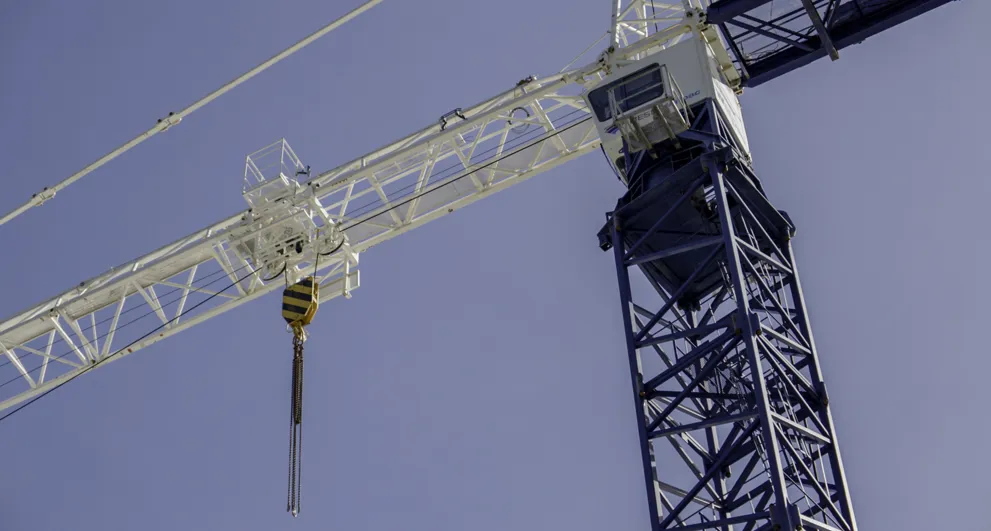 View From Below Of A Blue And White Construction Crane