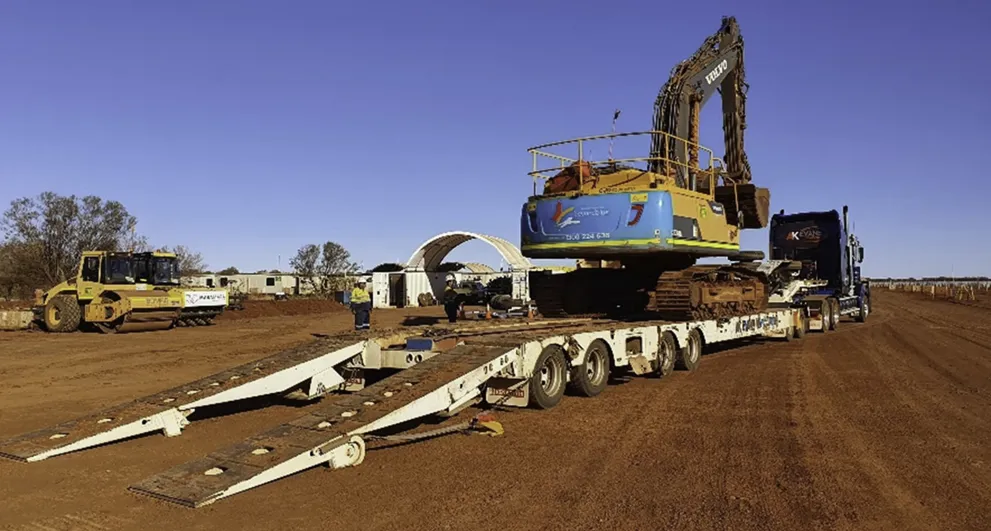 Workers and heavy equipment at the Alinta Solar farm project.