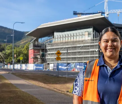 Indigenous worker standing in front of JCU project 