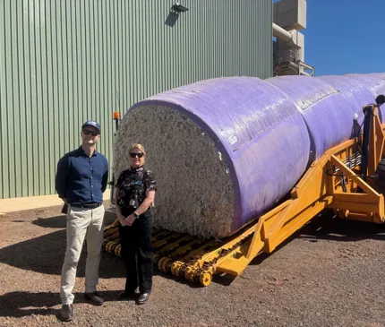 Louie Trajkoski and Tracey Hayes at the Kimberley Cotton Gin standing in front of the first delivery of cotton