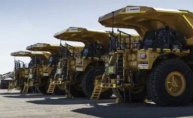 Pembroke Olive Downs Steelmaking Coal Project Four Large Orange Mining Trucks