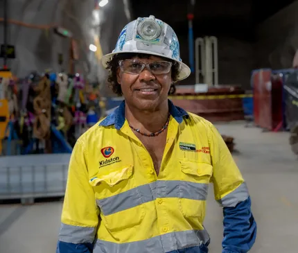 Ross Rosas in the underground cavern wearing high visibility safety uniform at the Genex Kidston Hydro Pumped Storage Project