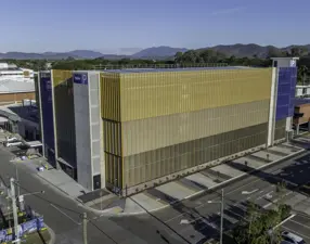 Mater Health Multi Storey Carpark Townsville Aerial View Yello Wand Blue Exterior Mountains In Background