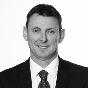 Portrait of Craig Doyle wearing a suit in black and white