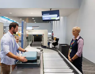 Queensland Airports Limited Townsville Airport Redevelopment Security Check Father With Luggage