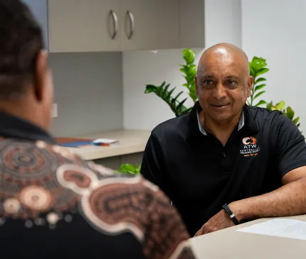 Tony Martens at the Australian Training Works office speaking to their Indigenous Liaison Officer