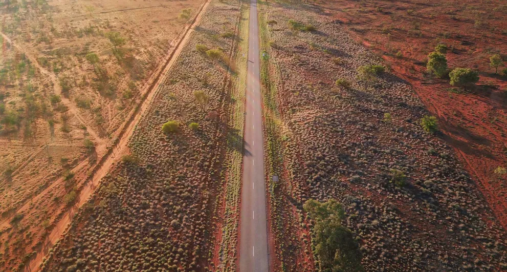 An Aerial View Of A Long Road In The Australian Outback