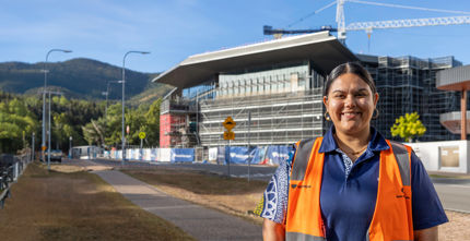 Indigenous worker standing in front of JCU project 