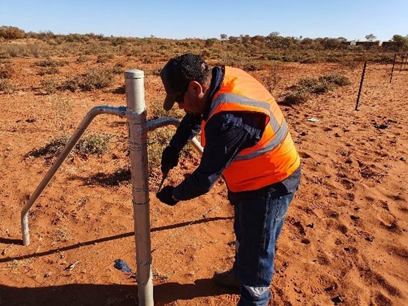 Indigenous worker constructing a fence post at Kalium Lakes SOP Project
